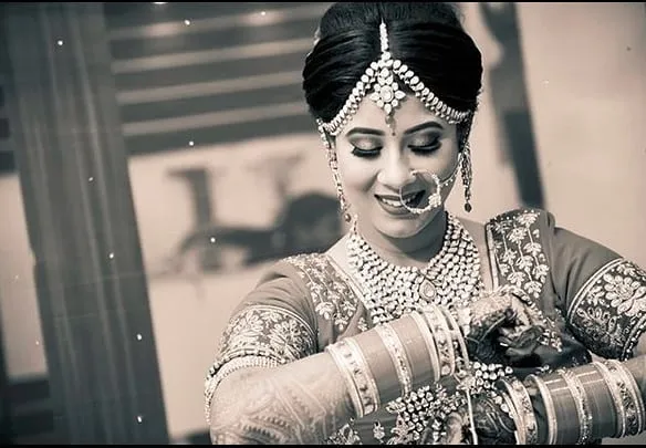 Monochrome detail of bridal bangles and mehendi