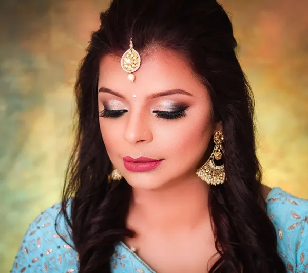 Close detail of bridal eye makeup with blue and gold jewellery