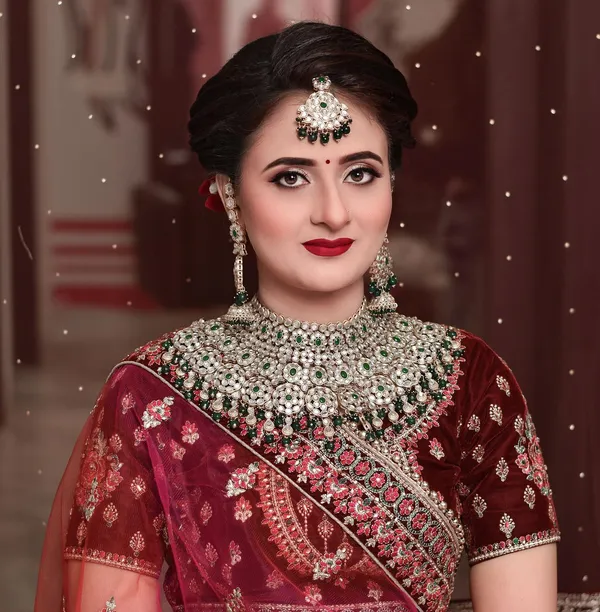 Bride in a maroon lehenga with a soft matte base and defined eyes