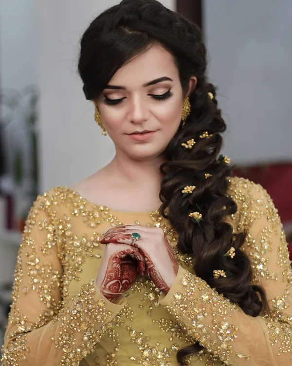 Engagement look in gold with fresh mehendi on both hands