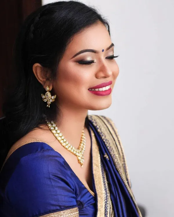 Party look in a blue saree with gold jewellery