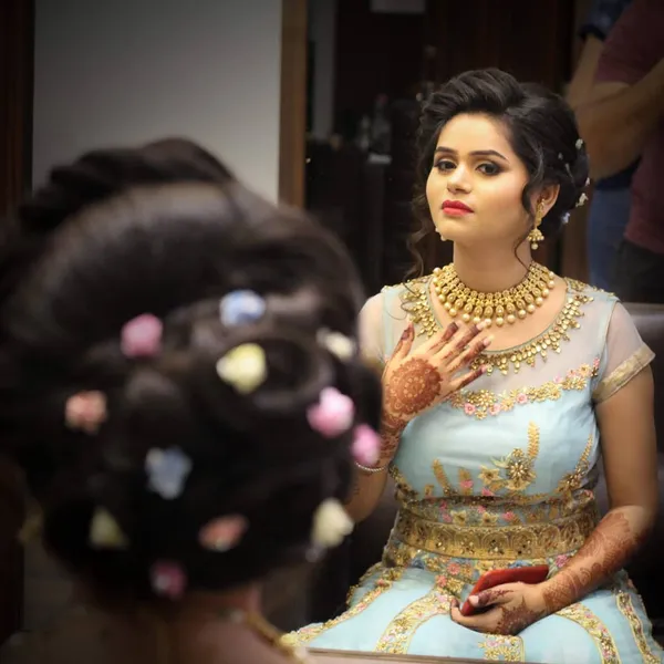 Party hairstyling — floral updo with soft glam makeup