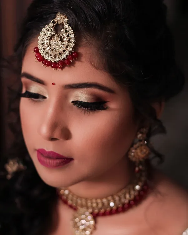 Close party makeup portrait in maroon and gold