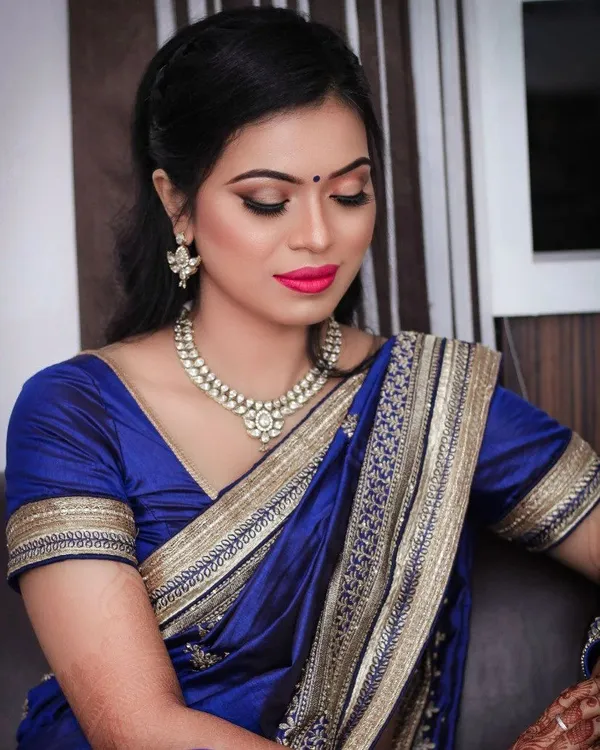 Classic party makeup with a navy saree and a soft lip
